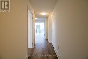 Milton (Om Old Milton) condo for rent - A hallway with a door on the left and a window on the right.