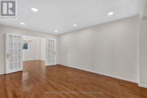 Richmond Hill (South Richvale) apartment for rent - A spacious room with wooden floors and white walls.