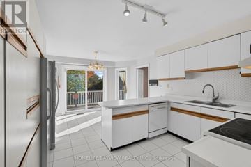 Richmond Hill (South Richvale) apartment for rent - A kitchen with white cabinets and a refrigerator.