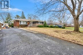 St. Catharines (Carlton/Bunting) apartment for rent - A house with a driveway in front of it.