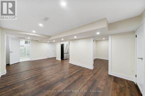 St. Catharines (Carlton/Bunting) apartment for rent - A spacious room with wooden floors and white walls.