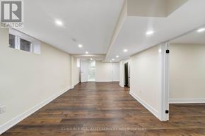 St. Catharines (Carlton/Bunting) apartment for rent - A long, empty hallway with wooden floors and white walls.