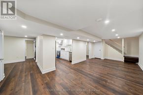 St. Catharines (Carlton/Bunting) apartment for rent - A spacious room with wooden floors and white walls.