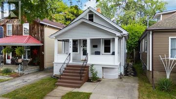 Sarnia apartment for rent - A house with a red awning and a white porch.