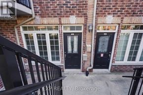 Kitchener townhouse for rent - A building with a black door and windows with white frames.