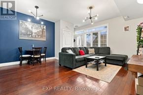 Kitchener townhouse for rent - A living room with a grey couch and a wooden floor.