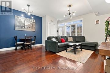 Kitchener townhouse for rent - A living room with a grey couch and a wooden floor.
