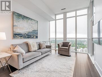 Toronto (Annex) condo for rent - A living room with a grey couch and a painting on the wall.