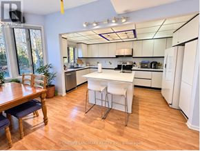 Toronto (Banbury-Don Mills) apartment for rent - A kitchen with white appliances and a wooden table.