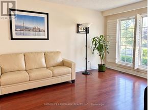 Toronto (Banbury-Don Mills) apartment for rent - A living room with a couch, a floor lamp, and a plant.