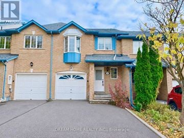 Richmond Hill (Rouge Woods) townhouse for rent - A two-story house with a blue garage door.