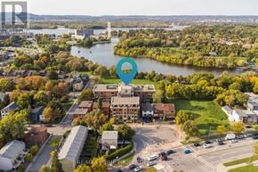 Ottawa condo for rent - A bird's eye view of a city with a large building in the center and a river running through it.