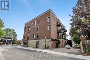 Ottawa condo for rent - A brick building with a no parking sign in front of it.