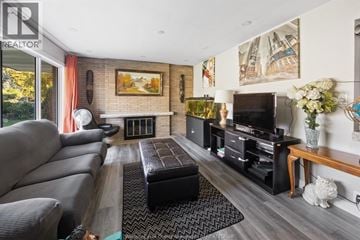Windsor apartment for rent - A living room with a grey couch and a fireplace.
