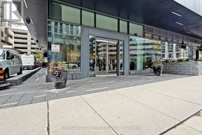 Toronto (Bay Street Corridor) condo for rent - A building with a glass facade and a sign that says "RE/MAX REALTY SERVICES INC. Brokerage".