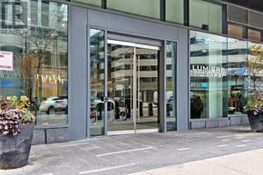 Toronto (Bay Street Corridor) condo for rent - The front of a building with a glass door and windows.