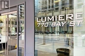 Toronto (Bay Street Corridor) condo for rent - A glass window with a sign that says "LUMIERE 770 BAY ST".