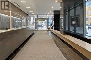 Toronto (Bay Street Corridor) condo for rent - A hallway with a glass door and a sign that says "REALTOR".
