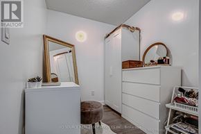 Toronto (Waterfront Communities) condo for rent - A white dresser with a mirror and a small table with a plant on it.