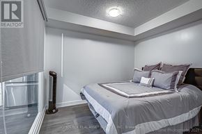 Toronto (Waterfront Communities) condo for rent - A bedroom with a bed, pillows, and a window with blinds.