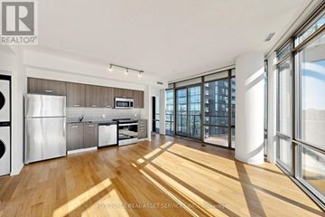 Toronto (Bay Street Corridor) condo for rent - A modern kitchen with stainless steel appliances and wooden flooring.