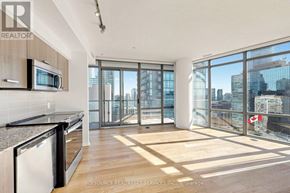 Toronto (Bay Street Corridor) condo for rent - A modern kitchen with a view of the city.