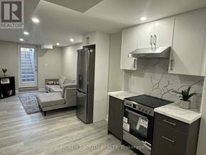Whitby (Williamsburg) apartment for rent - A modern kitchen with a refrigerator, oven, and stove top.