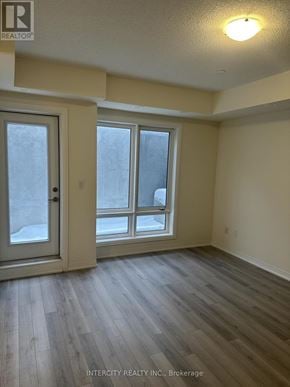 Toronto (Malvern) townhouse for rent - A room with a sliding glass door and a wooden floor.