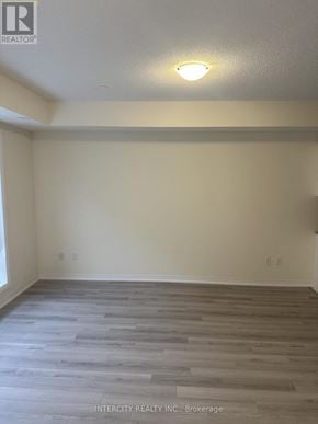 Toronto (Malvern) townhouse for rent - A room with wooden flooring and a light on the ceiling.