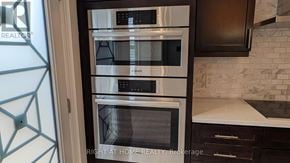 East Gwillimbury (Queensville) apartment for rent - A modern kitchen with a stainless steel oven and microwave.