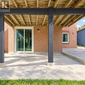 Innisfil (Alcona) apartment for rent - A house with a covered patio and a brick wall.