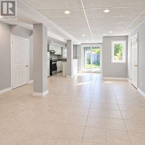 Innisfil (Alcona) apartment for rent - A spacious room with tiled flooring and white walls.