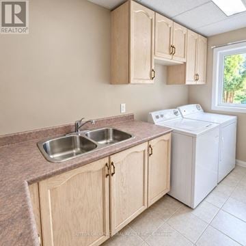 Innisfil (Alcona) apartment for rent - A kitchen with wooden cabinets and a white dishwasher.