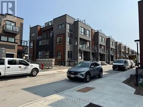 Newmarket (Glenway Estates) townhouse for rent - A row of modern townhouses with cars parked in front.