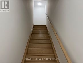 Newmarket (Glenway Estates) townhouse for rent - A staircase with wooden steps and a white wall on one side.