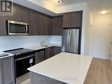 Newmarket (Glenway Estates) townhouse for rent - A kitchen with a white counter top and stainless steel appliances.