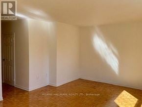 Mississauga (Cooksville) house for rent - A room with a wooden floor and white walls, with sunlight shining through a window.