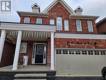 Milton (Ha Harrison) apartment for rent - A brick house with a black door and a white garage door.