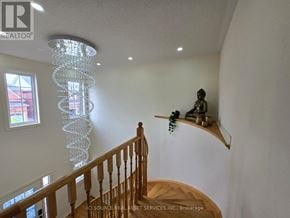 Milton (Ha Harrison) apartment for rent - A chandelier hangs from the ceiling in a room with a wooden staircase.
