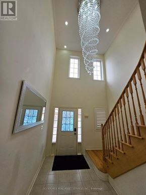Milton (Ha Harrison) apartment for rent - A hallway with a chandelier, a mirror, and a staircase.