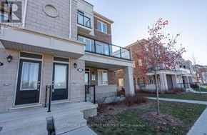 Kitchener townhouse for rent - A building with a tree in front of it.
