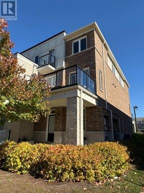 Kitchener townhouse for rent - A modern two-story building with a balcony on the second floor.