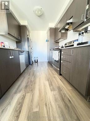 Kitchener townhouse for rent - A kitchen with wood flooring and dark cabinets.