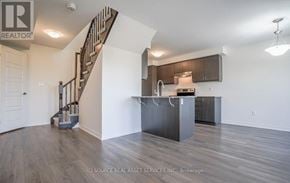 Kitchener townhouse for rent - A spacious kitchen with a staircase on the left side.