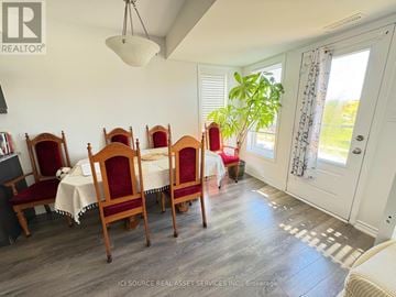 Kitchener townhouse for rent - A dining room with a table set for six with chairs with red covers.