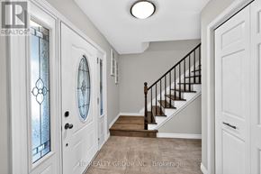 Hamilton (Freelton) apartment for rent - A hallway with white doors and a wooden staircase.