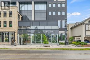 Waterloo condo for rent - A modern building with a glass facade and a sculpture in front of it.