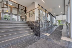 Waterloo condo for rent - A set of stairs with a glass railing and a tiled floor.