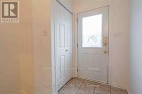 South Glengarry apartment for rent - A white door is in a room with a tiled floor.