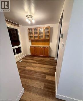 Cambridge townhouse for rent - A room with wooden flooring and a wooden cabinet with glass doors.